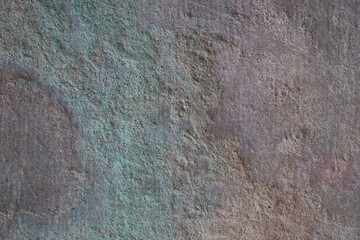 Green copper patina on a stone wall