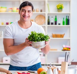 Young male cook working in the kitchen