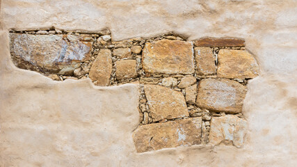 Stone brick wall and cracked plaster surface background and copy space. Traditional old weathered construction materials brick wall wallpaper 