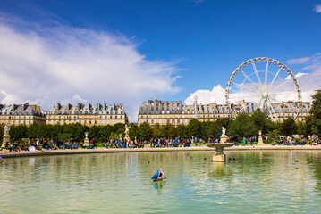Fototapeta premium Scenic view of pond at Tuileries garden with Ferris wheel in background. Place de la Concorde Paris
