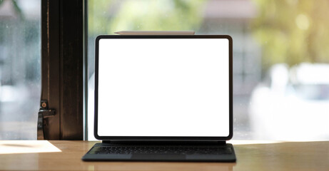 Blank screen Laptop computer and poster workspace background in modern office