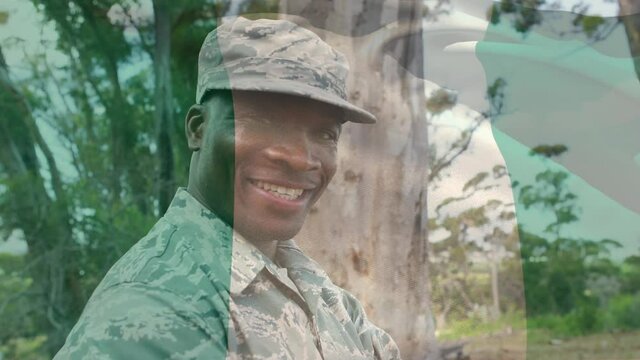 Digital composition of waving nigeria flag against portrait of soldier smiling at training camp