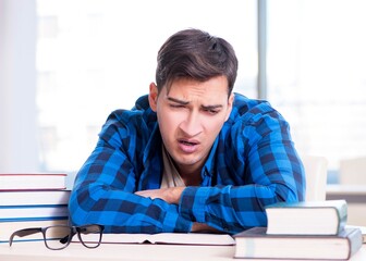 Student studying in the empty library with book preparing for ex