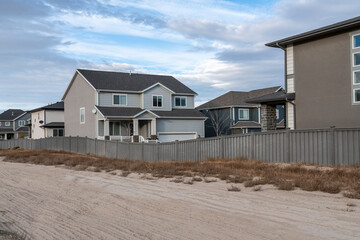 Outside of a residential area with large houses and fence