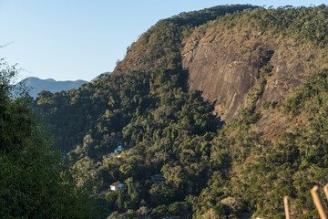Aerial view of Itaipava, Petrópolis. Mountains with blue sky and some clouds around. Vegetation in the foreground. Mountain region of Rio de Janeiro, Brazil.