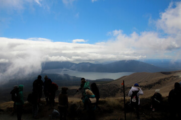 People looking down lake from high ground