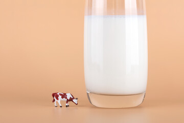A glass of milk and a cow model