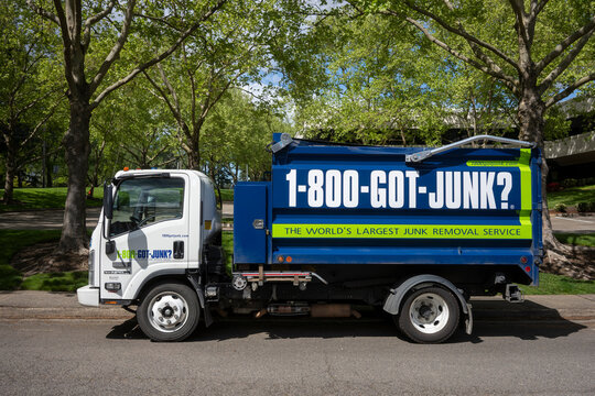 Tigard, OR, USA - May 2, 2021: A 1-800-GOT-JUNK garbage truck is seen on the streets in Tigard, Oregon. Rubbish Boys Disposal Service (RBDS) Inc. is a Canadian franchised junk removal company.