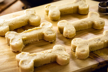 bone shaped cookie about to be cooked, raw dough, homemade pet snack