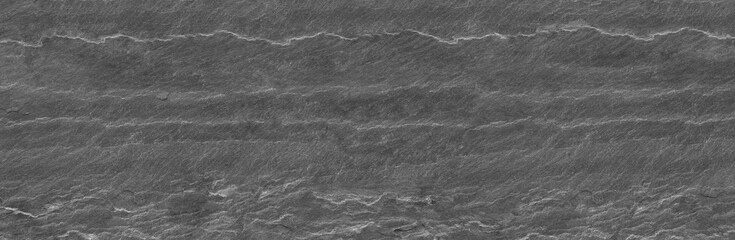 Panorama dark gray stone background with copy space. Black grunge banner with rock texture. Rock background with cracked surface.