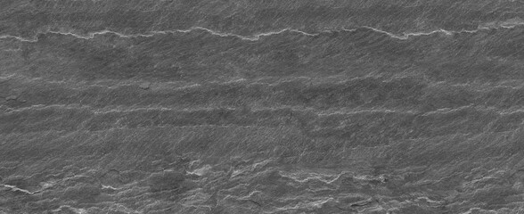 Panorama dark gray stone background with copy space. Black grunge banner with rock texture. Rock background with cracked surface.