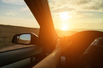 a trip to the sea by car. car on the beach sunset