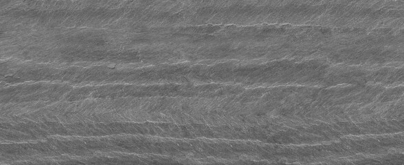 Panorama dark gray stone background with copy space. Black grunge banner with rock texture. Rock background with cracked surface.