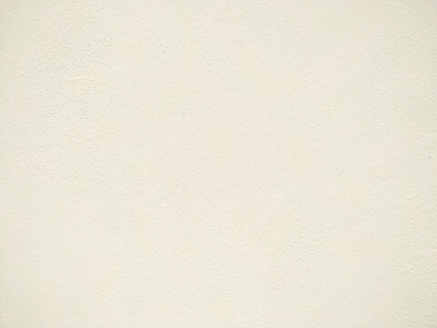 Surface texture of the clear soft yellow cement wall background.