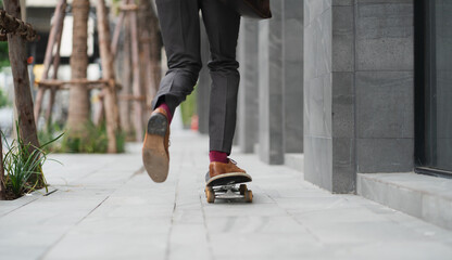 lifestyle businessman in suit riding on skateboard along street