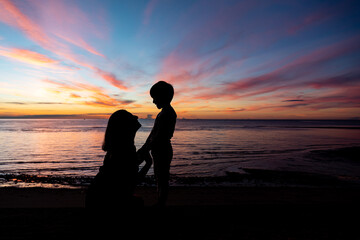 silhouette of family watching sunset at the beach in Hua Hin