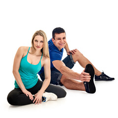 Fototapeta na wymiar Beautiful fitness couple posing together on white studio background