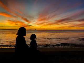 silhouette of family watching sunset at the beach in Hua Hin