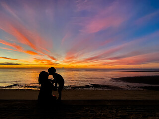 silhouette of family watching sunset at the beach in Hua Hin