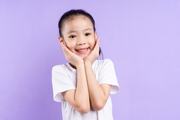 Portrait of Asian child on purple background
