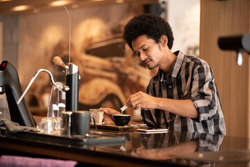 Hipster man filling sugar in hot coffee before drink