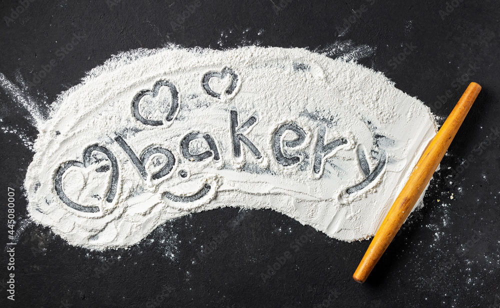 Aufkleber Abstract baking backgroun. Word bakery and heart is written on flour with rolling pin, top view