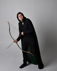 Full length portrait of a  brunette man wearing black shirt, waistcoat and a green velvet cloak...