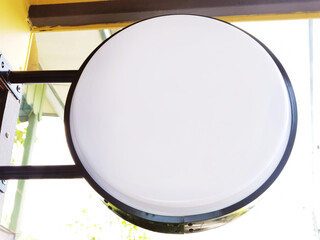 Blank round white signboard on the wall outdoor, mock up