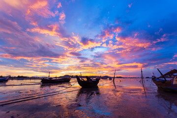 beautiful sunrise with boat on the sea summer at Chalong bay, Phuket province, Thailand. subject is blurred noise and low key.