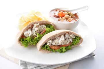chicken salad kebab open pocket bread serve with tomato soup and crispy potato chips combo set  in white background asian vegan halal menu
