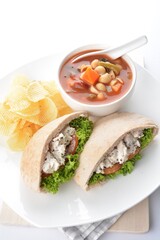 chicken salad kebab open pocket bread serve with tomato soup and crispy potato chips combo set  in white background asian vegan halal menu
