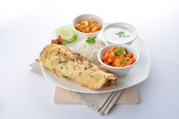 Indian baked roti prata canai with curry vegetables, yogurt sauce, pea bean and steamed white rice in white background asian vegan halal menu