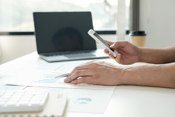 work from home, The hand of a man who works in finance sits at his desk at home and calculates financial graphs showing the results of his investments, planning the steps of his business growth