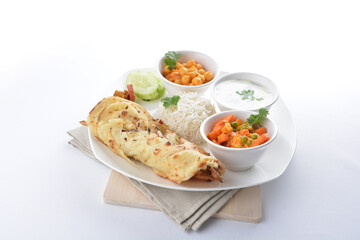 Indian baked roti prata canai with curry vegetables, yogurt sauce, pea bean and steamed white rice in white background asian vegan halal menu