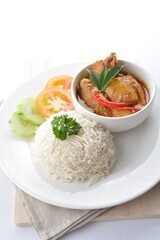 signature Malay nonya spicy curry chicken and potato with steamed white rice and salad in white background asian halal menu