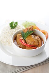 signature Malay nonya spicy curry chicken and potato with steamed white rice and salad in white background asian halal menu