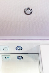 Recessed halogen lamp and reflection in the washbasin mirror.