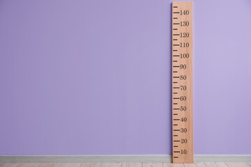 Big ruler for height measuring near color wall