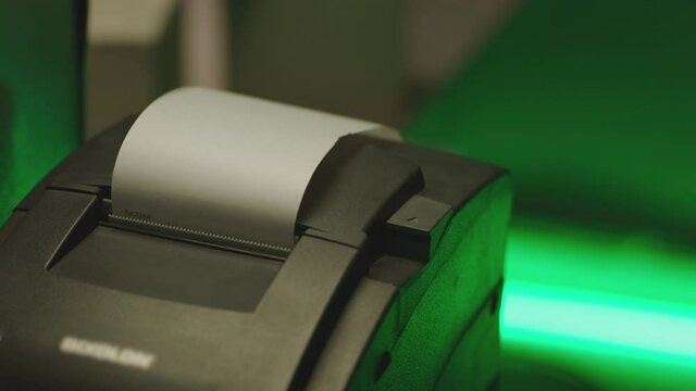 List of paper receipt with numbers getting out from the modern cash register  . Diagnostician Technological modern device special for diagnosing quality . Cash register electronic machine 