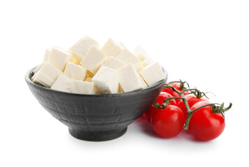 Bowl with pieces of feta cheese and tomato cherry on white background