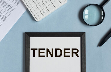 Tender word on office table, top view. Business inscription