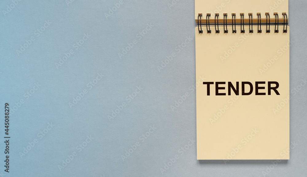 Poster tender word on notepad paper on blue gray background with copyspace for text. business banner with c