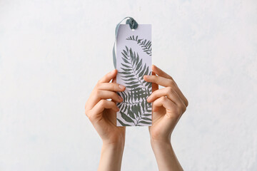 Woman with bookmark on white background