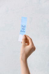 Woman with bookmark on white background
