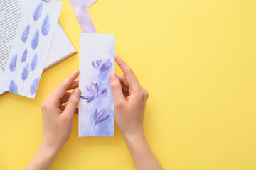 Woman with bookmark on color background