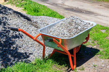 Wheelbarrow with gravel at the construction site