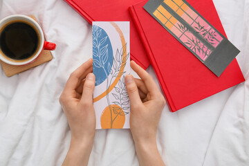 Woman with bookmarks and books on bed