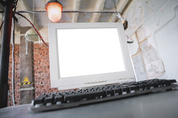 A blank screen computer monitor with copy space on the metal table background.
