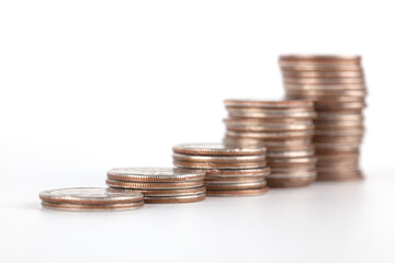 A row of increasing dollar coins on white background