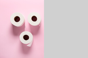 Rolls of toilet paper on color background
